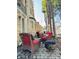 Outdoor patio with red cushioned wicker chairs and a fire pit, ideal for entertaining guests at 906 Franklin St, Columbus, IN 47201