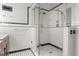 Detailed view of a walk-in shower with glass door, modern fixtures, and tiled walls and flooring at 906 Franklin St, Columbus, IN 47201