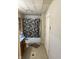 Bathroom features a blue vanity, a patterned shower curtain, and a utilitarian design at 911 W 3Rd St, Anderson, IN 46016