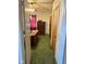 A bedroom view with green carpet, an armoire, and a ceiling fan, offering a comfortable living space at 911 W 3Rd St, Anderson, IN 46016