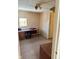Bedroom features a utilitarian desk, neutral carpet, and natural light at 911 W 3Rd St, Anderson, IN 46016