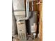 This area features a modern Carrier furnace and a Richmond water heater, set against a wood-paneled wall at 911 W 3Rd St, Anderson, IN 46016