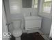Well-lit bathroom with a modern vanity, toilet, and bright window offers a clean and functional design at 929 Gilbert Ave, Indianapolis, IN 46227