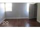 A bedroom with hardwood floors, a window, and a closet perfect for a restful retreat at 929 Gilbert Ave, Indianapolis, IN 46227
