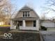 Charming two-story home with a covered front porch, inviting curb appeal, and a detached garage at 929 Gilbert Ave, Indianapolis, IN 46227