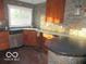 Modern kitchen featuring stainless steel appliances, stone backsplash, and breakfast bar at 929 Gilbert Ave, Indianapolis, IN 46227