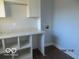 Bright laundry room with granite countertops and ample open shelving for organization and storage at 929 Gilbert Ave, Indianapolis, IN 46227