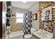 Bathroom with shower, bath, checkered curtain, tiled walls, and a pedestal sink at 960 Cameron St, Indianapolis, IN 46203