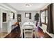 Bright dining room with a large white table, hardwood floors, and natural light from the windows at 960 Cameron St, Indianapolis, IN 46203