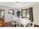 Well-lit dining area featuring a large table, hardwood floors, and a view to the kitchen at 960 Cameron St, Indianapolis, IN 46203
