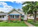Charming home featuring brick accents, blue trim, and lush landscaping, creating a welcoming curb appeal at 960 Cameron St, Indianapolis, IN 46203