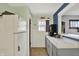 Vintage kitchen with white refrigerator, marble-look countertops and open view to the living area at 960 Cameron St, Indianapolis, IN 46203