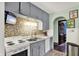 Traditional kitchen with gray cabinetry, stainless sink, tile backsplash and vintage-style appliances at 960 Cameron St, Indianapolis, IN 46203