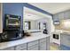 Kitchen features a marble-look countertop, range, tile backsplash and a pass-through to the living area at 960 Cameron St, Indianapolis, IN 46203
