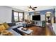 Comfortable living room featuring hardwood floors, a gray sectional, and a large TV at 960 Cameron St, Indianapolis, IN 46203