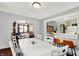 Dining room with hardwood floors, a large table, and open layout to the kitchen and living room at 960 Cameron St, Indianapolis, IN 46203