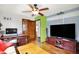 Open living room with hardwood floors, a TV, and a desk with computer at 960 Cameron St, Indianapolis, IN 46203