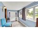 Bright sunroom featuring blue walls, hardwood floors, and an inviting atmosphere at 960 Cameron St, Indianapolis, IN 46203
