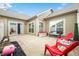 Backyard patio showing lawn chairs, stone wall, garden, and sliding glass doors at 112 Bridgemor Ln, Mooresville, IN 46158