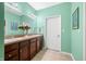 Bathroom featuring double sink vanity, framed mirror, neutral countertops and a closed white door at 112 Bridgemor Ln, Mooresville, IN 46158