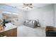 Neutral bedroom with large window, sofa, ceiling fan, desk, trunk and neutral carpeting at 112 Bridgemor Ln, Mooresville, IN 46158