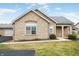 Charming single-story home with stone detailing, well-maintained lawn, and inviting entrance at 112 Bridgemor Ln, Mooresville, IN 46158