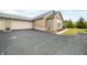Side view of the home showcasing attached garage, stone accents, and well-kept landscaping at 112 Bridgemor Ln, Mooresville, IN 46158