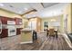 Open-concept kitchen with dark cabinets, stainless appliances, and eat-in dining area at 112 Bridgemor Ln, Mooresville, IN 46158