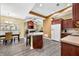 Open concept kitchen and dining area with stainless appliances and laminate flooring at 112 Bridgemor Ln, Mooresville, IN 46158