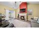 Spacious living room with a fireplace, high ceilings, and access to the backyard at 112 Bridgemor Ln, Mooresville, IN 46158