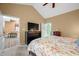 Spacious main bedroom with vaulted ceilings, featuring a large TV and access to the ensuite bathroom at 112 Bridgemor Ln, Mooresville, IN 46158