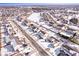 Aerial view of a residential area covered in snow, with visible roads, houses, and a nearby open field at 11835 Bengals Dr, Fishers, IN 46037
