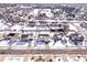 An aerial view showcases houses and streets covered with snow, highlighting the winter landscape of the residential area at 11835 Bengals Dr, Fishers, IN 46037