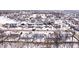 An aerial view shows a neighborhood covered in snow, with houses, trees, and streets visible from above at 11835 Bengals Dr, Fishers, IN 46037