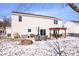 Spacious backyard featuring a patio with outdoor seating, fire pit, and snow covered yard at 11835 Bengals Dr, Fishers, IN 46037
