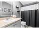 Well-lit bathroom featuring a single sink vanity, decorative shelves and updated fixtures at 11835 Bengals Dr, Fishers, IN 46037