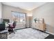 Bright home office features a window, desk, and storage cabinet with dark wood floors and area rug at 11835 Bengals Dr, Fishers, IN 46037
