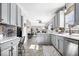 A stylish kitchen with stainless steel appliances, breakfast bar, and an open layout to the living room at 11835 Bengals Dr, Fishers, IN 46037