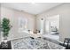 A brightly lit home office featuring a desk, chair, and view to the dining area at 11835 Bengals Dr, Fishers, IN 46037