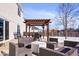 Cozy backyard patio featuring comfortable seating under a wooden pergola at 11835 Bengals Dr, Fishers, IN 46037
