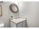 Charming powder room with a decorative mirror and pedestal sink with updated plumbing fixtures at 11835 Bengals Dr, Fishers, IN 46037
