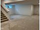 Finished basement featuring a carpeted area with stairs leading up to the main floor and a small window at 1225 Amberley Way, Westfield, IN 46074