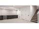 Finished basement with carpet, storage cabinets, mini fridge and nearby staircase at 1225 Amberley Way, Westfield, IN 46074
