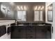 Modern bathroom featuring double sink vanity, dark tile accent wall and decorative mirrors at 1225 Amberley Way, Westfield, IN 46074