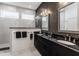 Modern bathroom with black herringbone tiled accent wall and double vanity at 1225 Amberley Way, Westfield, IN 46074