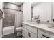 Modern bathroom featuring a shower-tub combo, sleek vanity with white countertop and grey tile accent wall at 1225 Amberley Way, Westfield, IN 46074