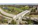 Stone and concrete bridge with white railings spanning a road and golf course with pond at 1225 Amberley Way, Westfield, IN 46074