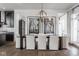Elegant dining area featuring a modern chandelier and large art pieces at 1225 Amberley Way, Westfield, IN 46074