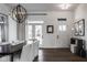 Elegant dining room with modern chandelier, white chairs, and doorway views to the outdoors at 1225 Amberley Way, Westfield, IN 46074