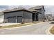 Two-story home featuring gray siding, stone accents, an attached two-car garage, and well-kept landscaping at 1225 Amberley Way, Westfield, IN 46074